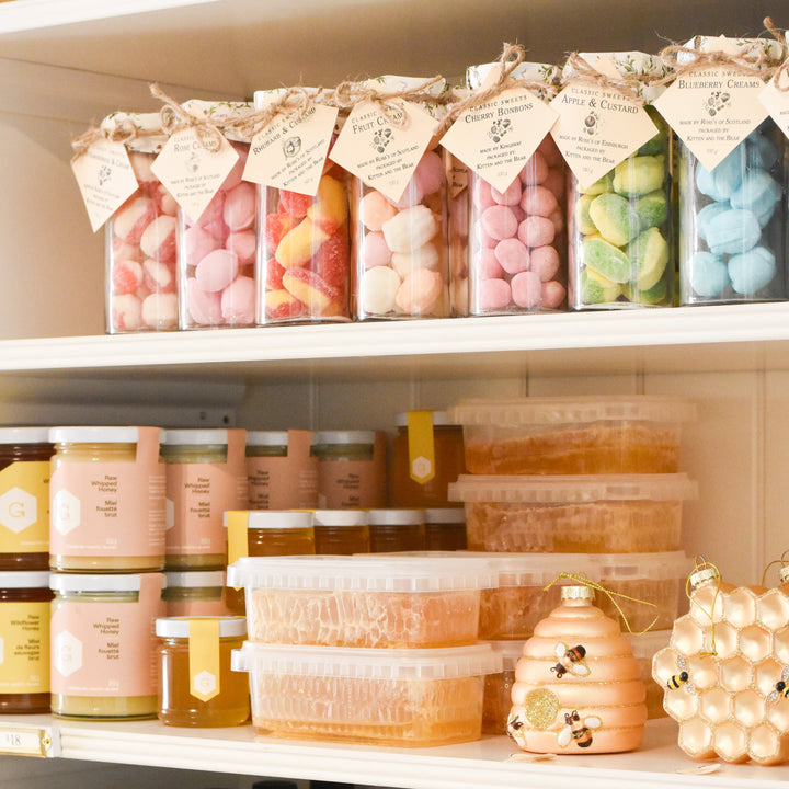 Shelf with various products including jars, bottles, and containers.