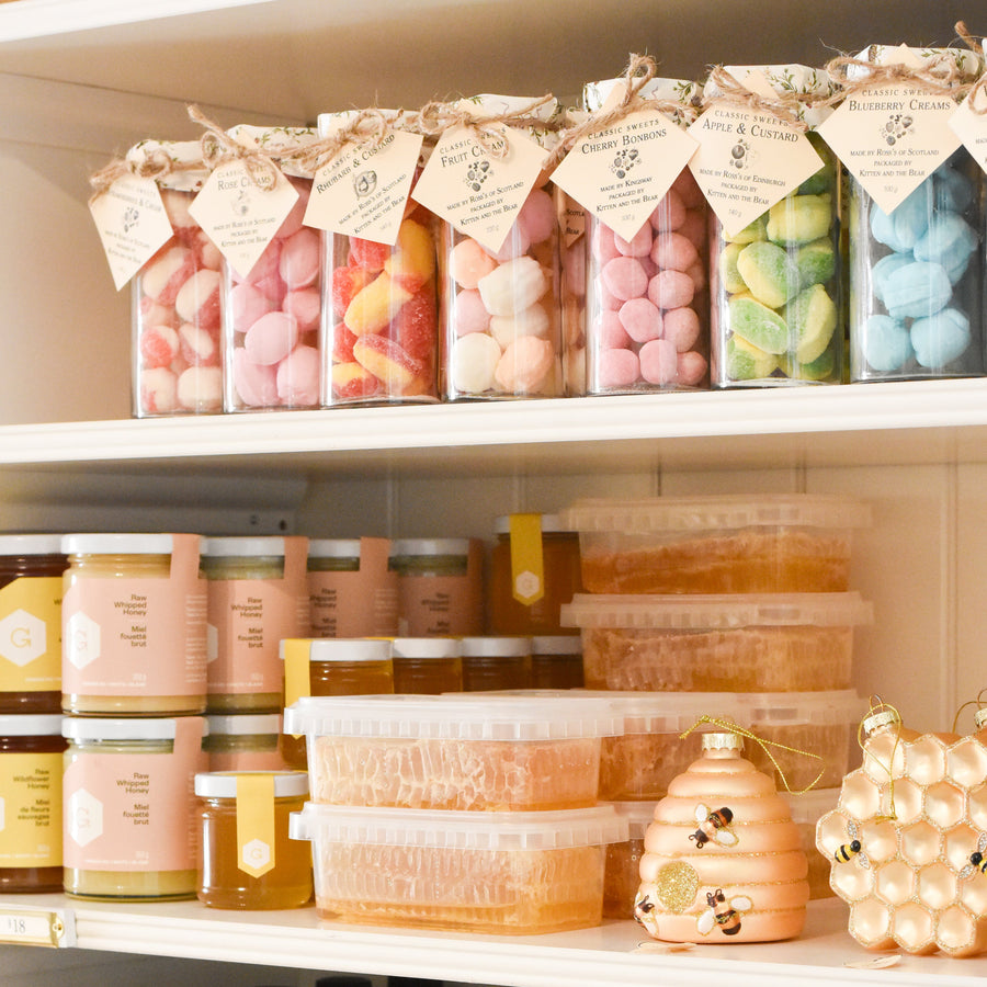 Shelf with various products including jars, bottles, and containers.