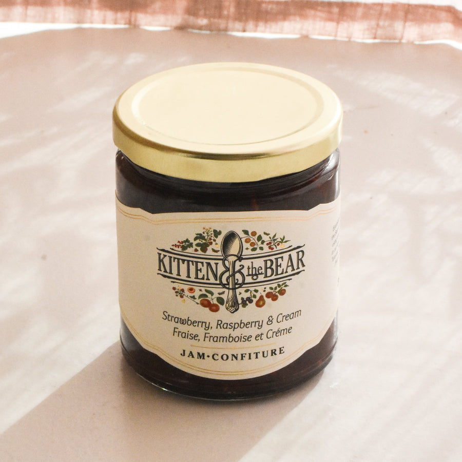Jar of jam with a decorative label on a light background