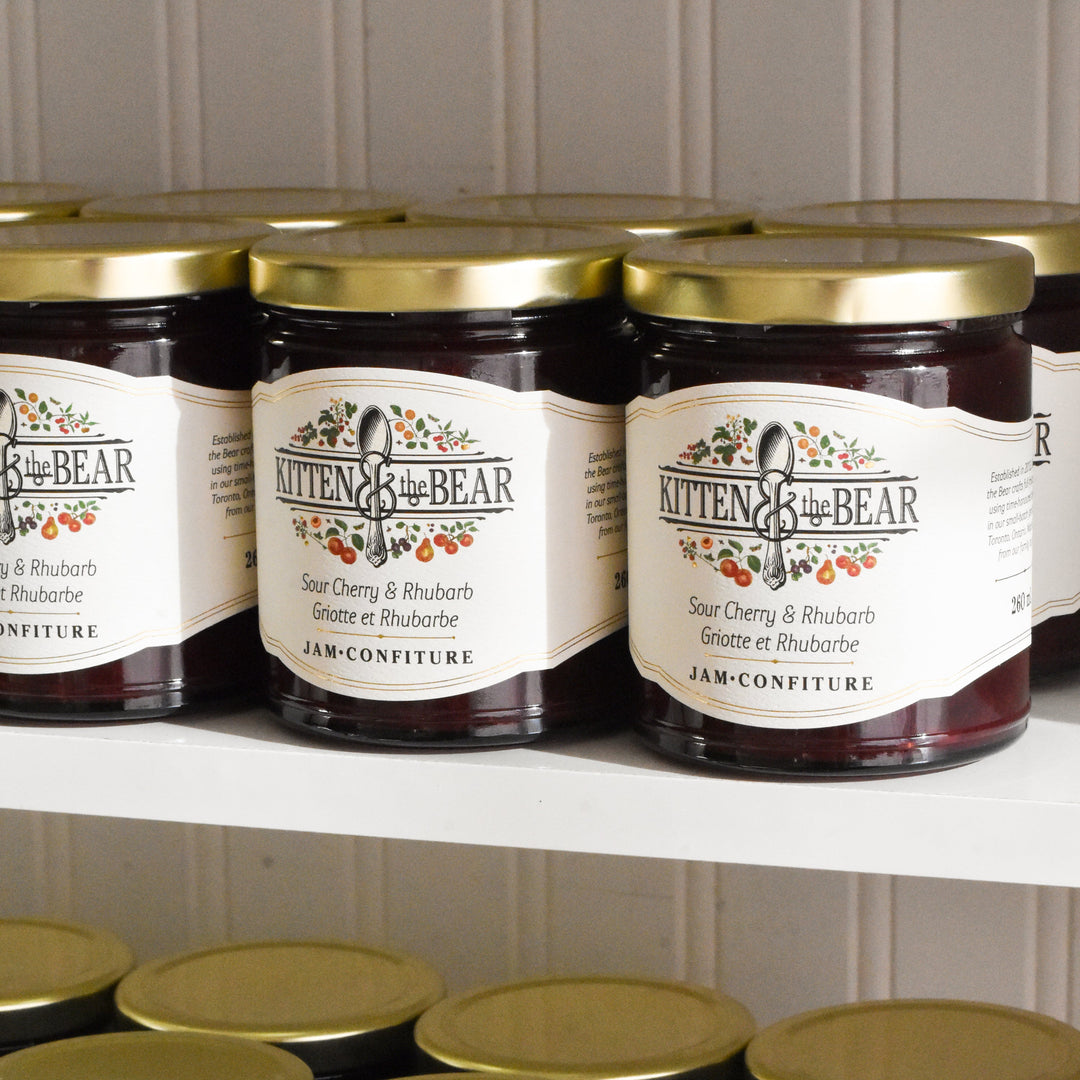 Jars of Kitten & the Bear jam on a shelf with a neutral background